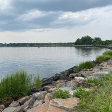 daytime view of water and shoreline with rocks at Great Kills Park, one of several Staten Island beaches