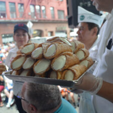 person holding a tray of cannolis at the San Gennaro Festival