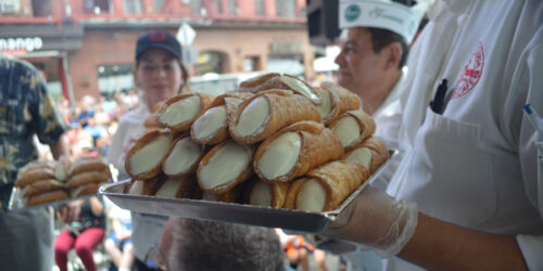 person holding a tray of cannolis at the San Gennaro Festival