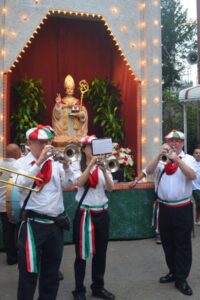three musicians perform with instruments at the San Gennaro Festival