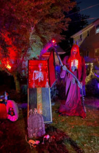 the yard of a house decorated at night for Halloween